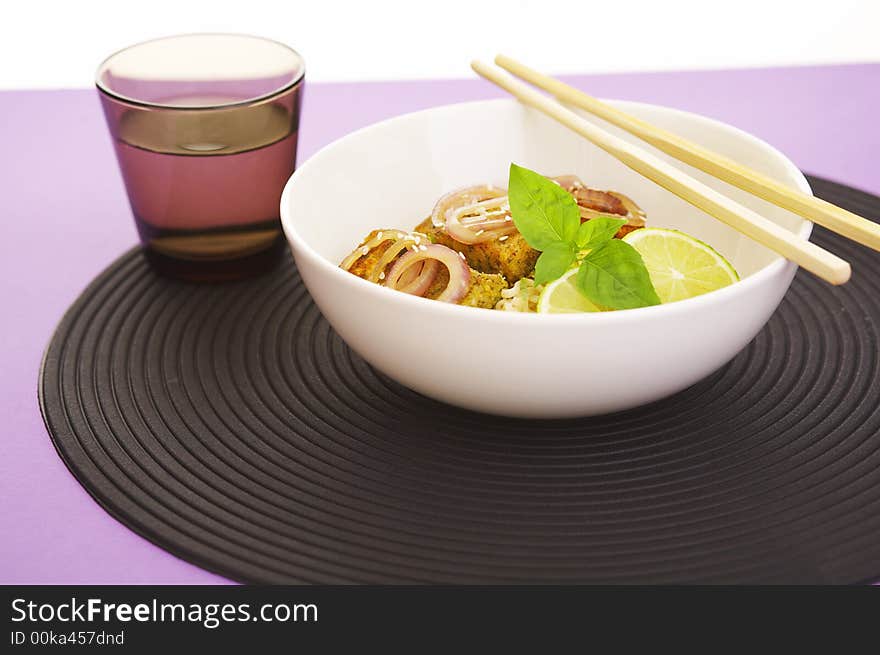 Asian style noodles and deep fried fish on purple background. Asian style noodles and deep fried fish on purple background