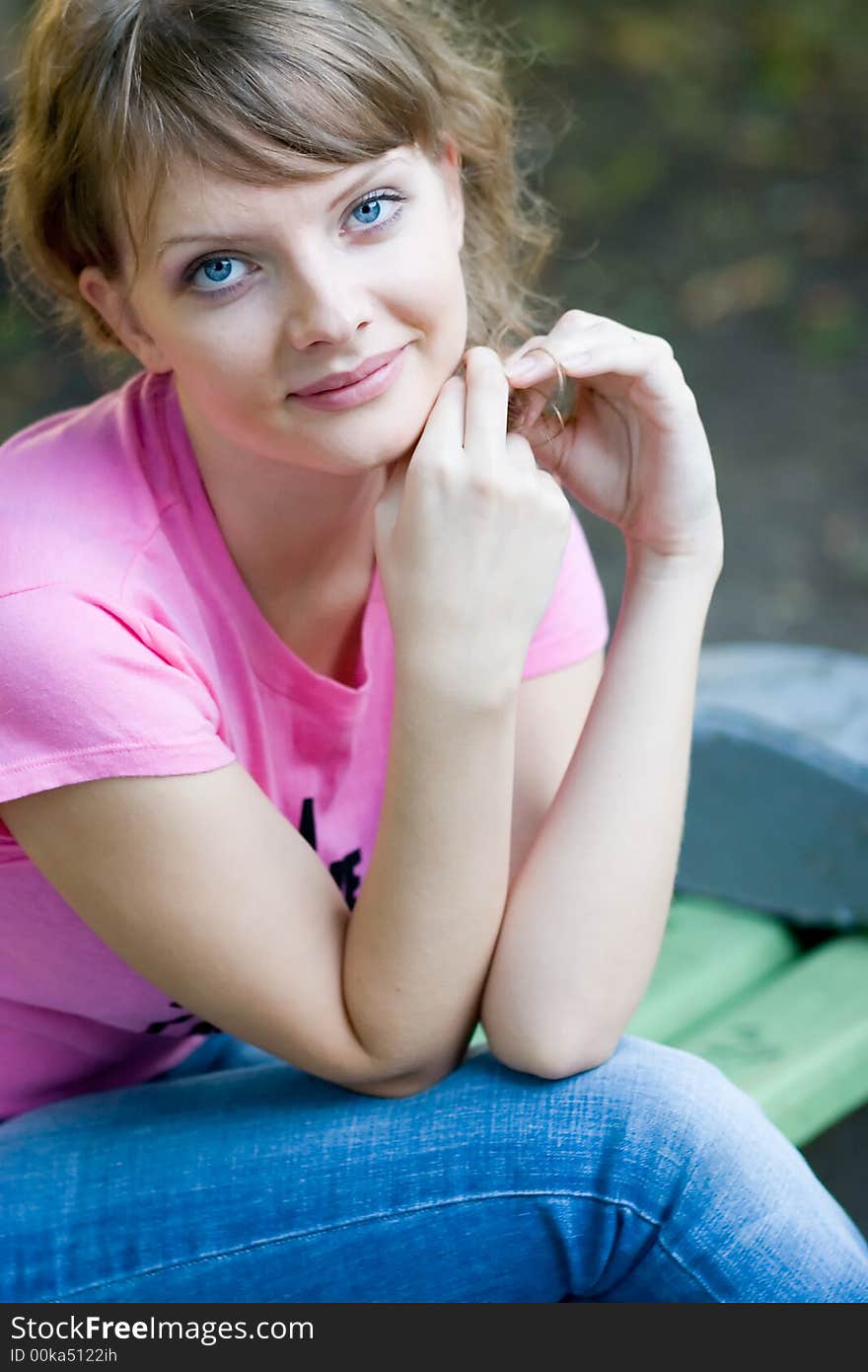 Young woman siting on bench. Young woman siting on bench