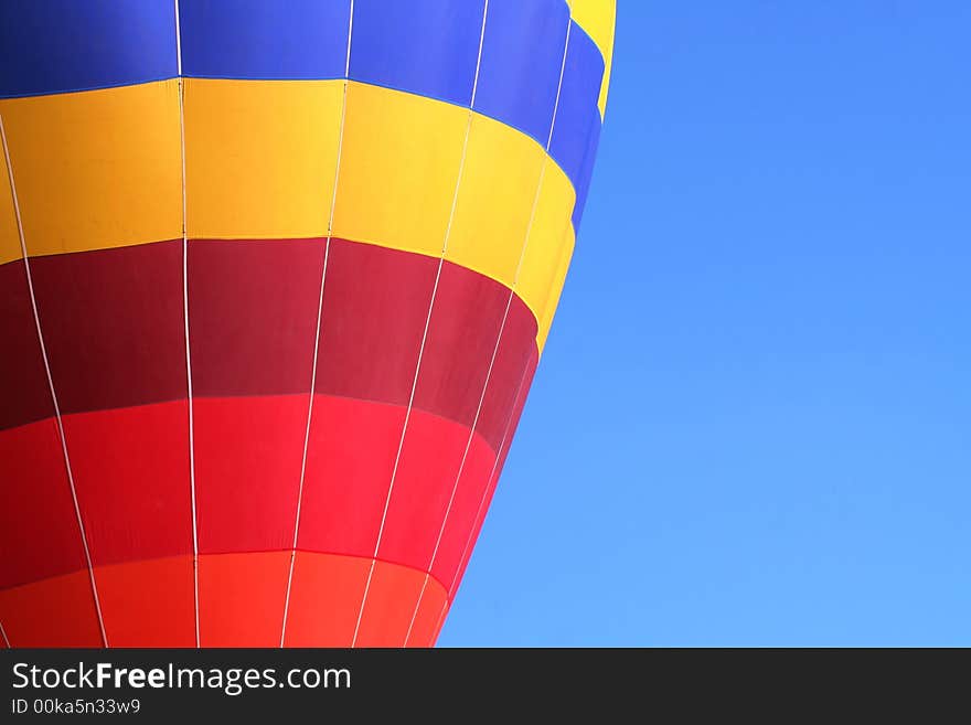 Colorful dirigible on blue sky background