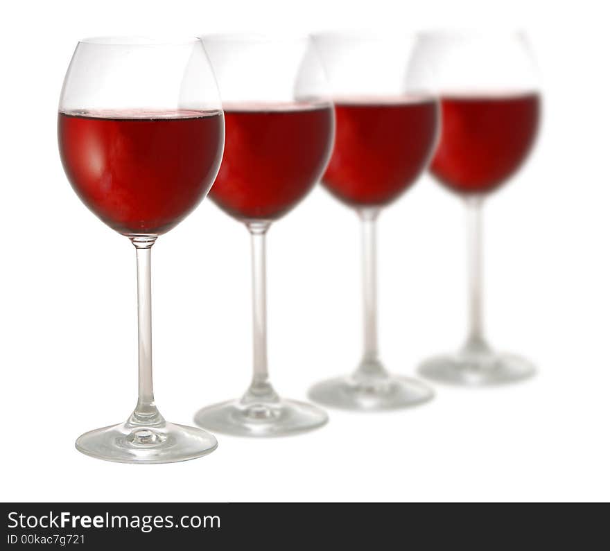 Four glasses of red wine isolated on white background