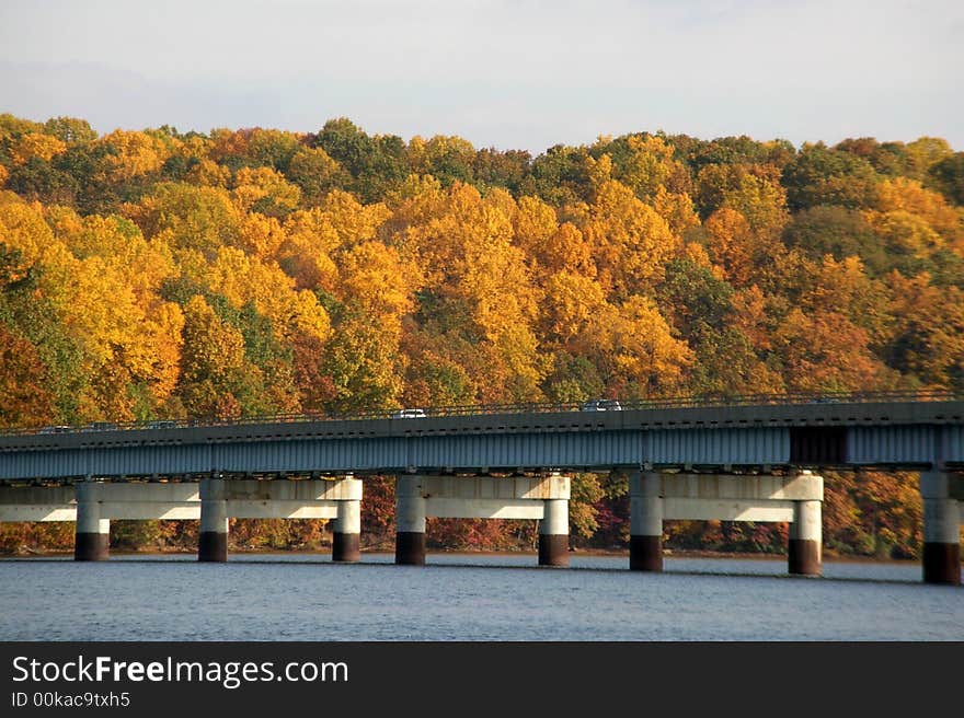 Bridge over the reservoir with fall foliage in the background. Bridge over the reservoir with fall foliage in the background.