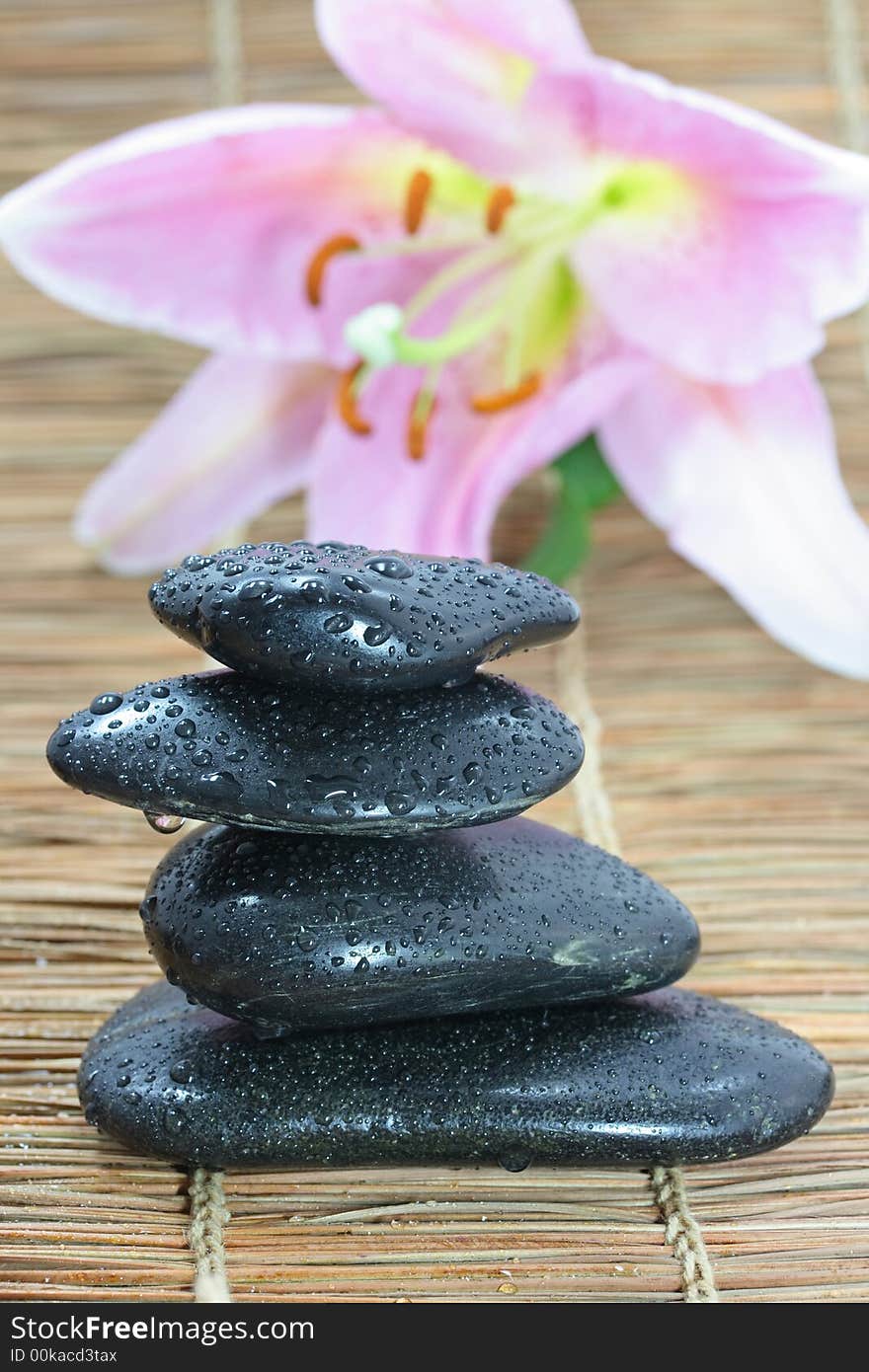 Pyramid of four stones on bamboo mat