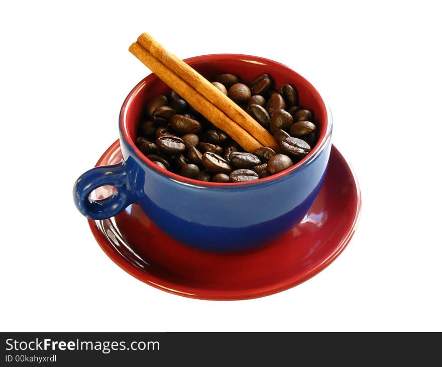 Coffee bens and a cinnamon stick with a colorful cup isolated on a white background. Coffee bens and a cinnamon stick with a colorful cup isolated on a white background