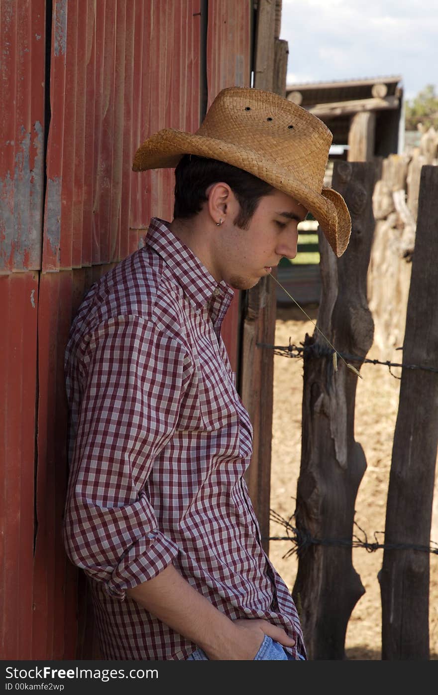 A young cowboy hanging out at the corral. A young cowboy hanging out at the corral