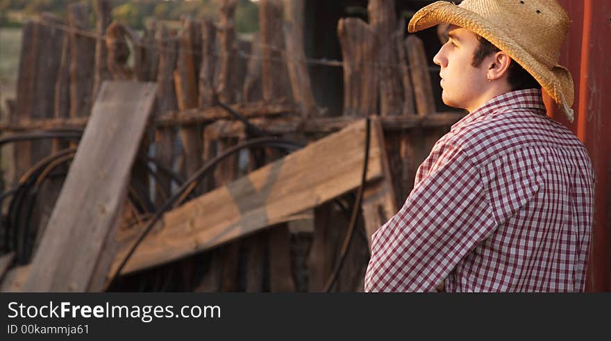 A young cowboy hanging out at the corral. A young cowboy hanging out at the corral