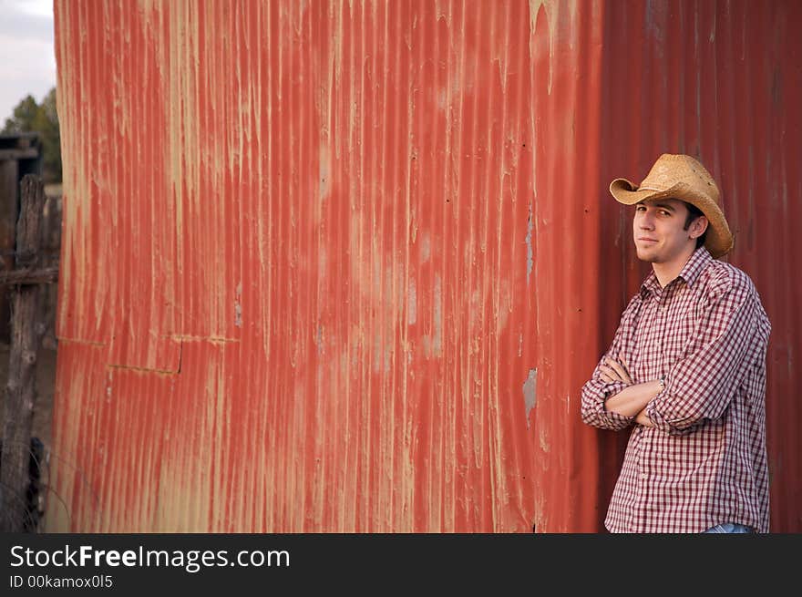 A young cowboy hanging out at the corral. A young cowboy hanging out at the corral