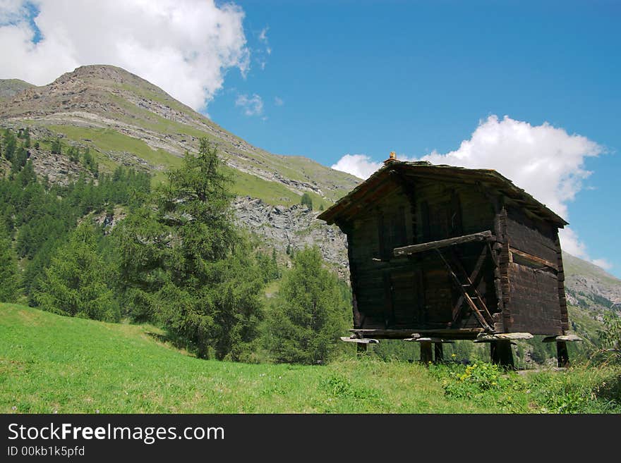 Old authentic obsolete swiss wooden houses in village in rocky high mountains. Switzerland, europe. Old authentic obsolete swiss wooden houses in village in rocky high mountains. Switzerland, europe.