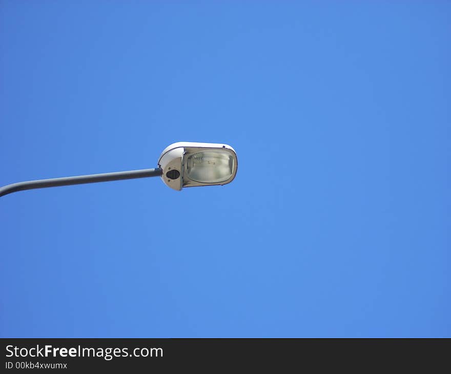 A street-lamp under a clear blue sky in summer. A street-lamp under a clear blue sky in summer