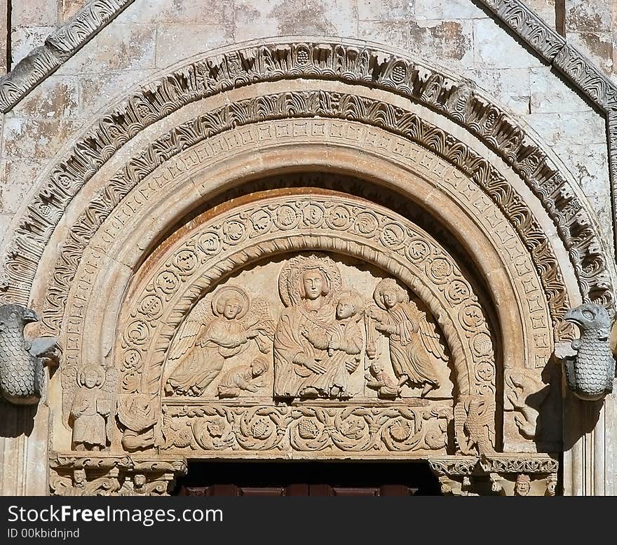 A romanic portal depicting our lady with baby christ, from a church in Monte Sant'Angelo, Italy