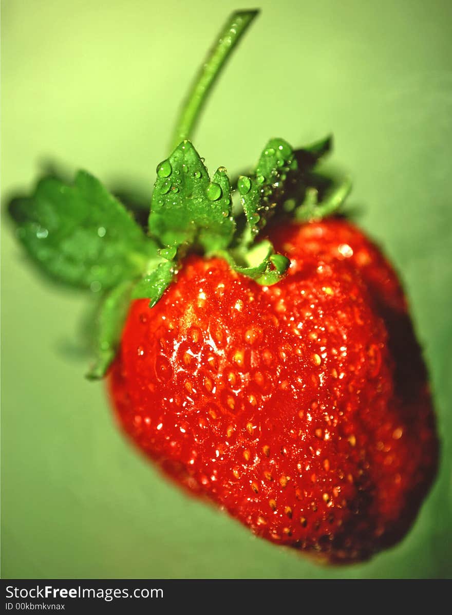 Red strawberry on a green background