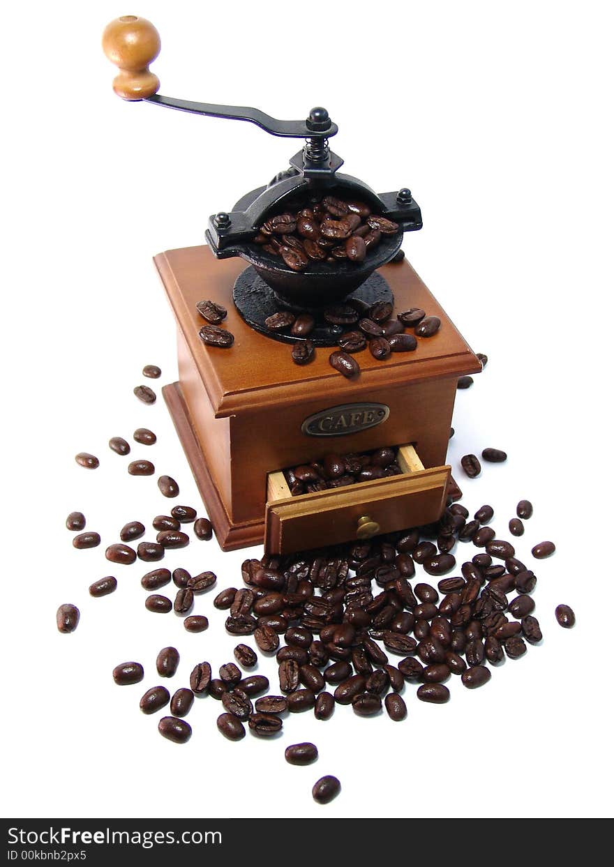 Coffee grinder and large coffee beans on a white background.