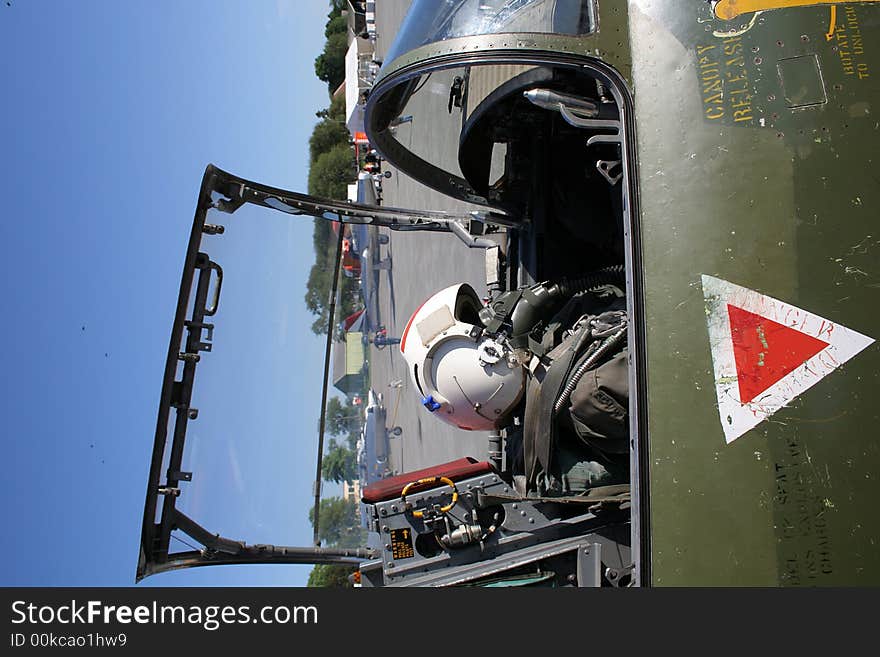 Open cockpit of a jet fighter, with a dummy placed inside.