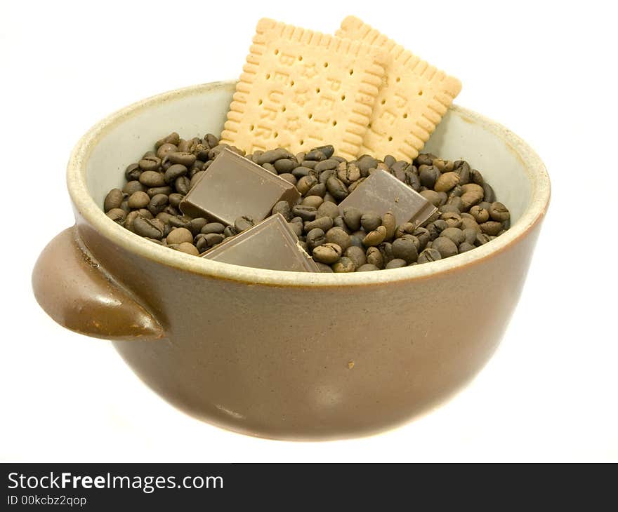 Brown bowl with coffee beans, chocolate and biscuit