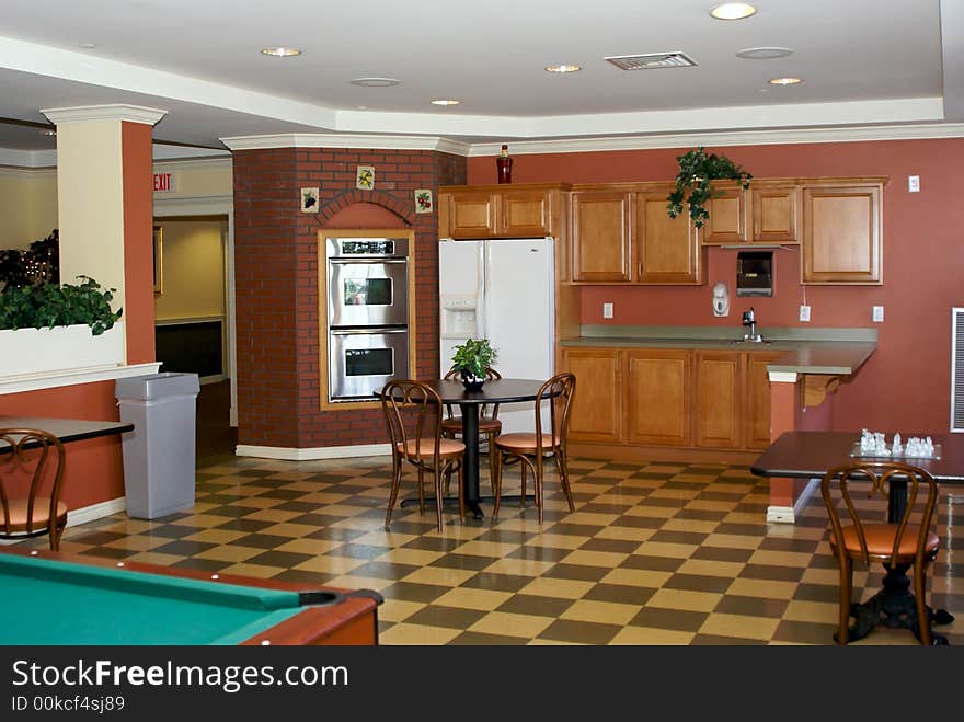 Bistro style room with checkered floor, tables, oven, sink, counter