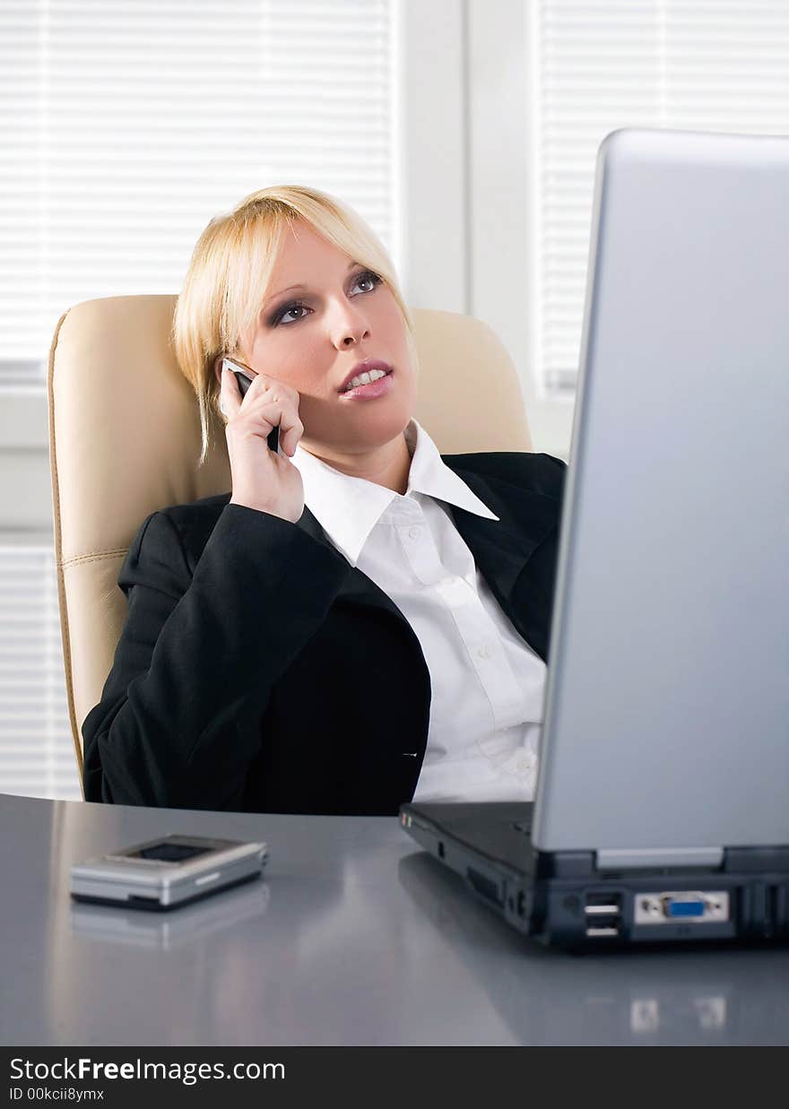 Businesswoman speaking on the mobile phone in the office. Businesswoman speaking on the mobile phone in the office