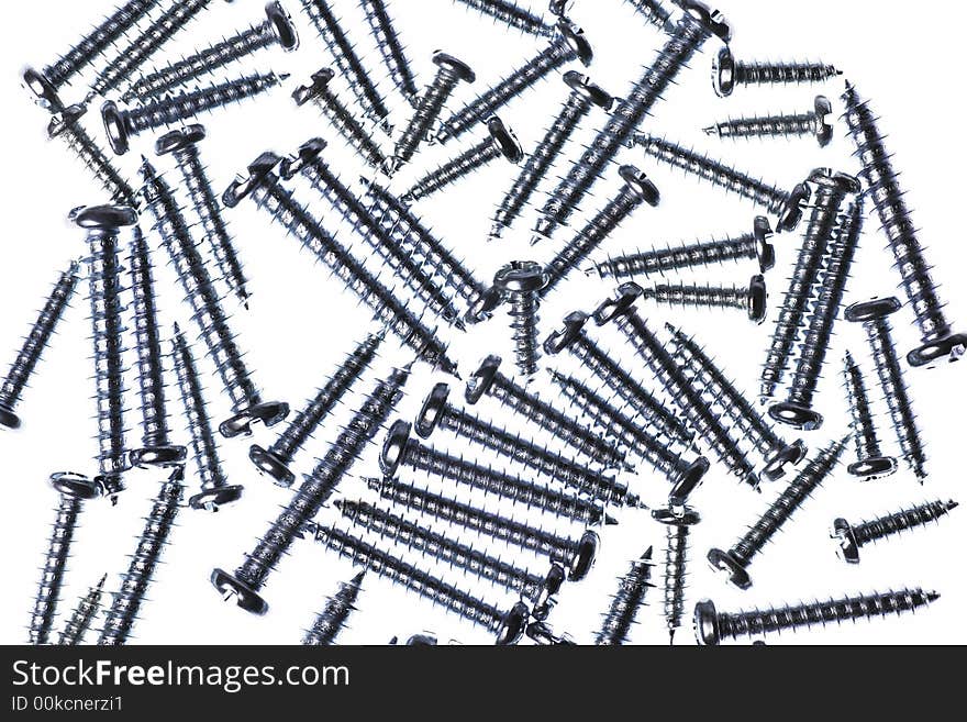 Many Spiral Metal Screws On A White Background