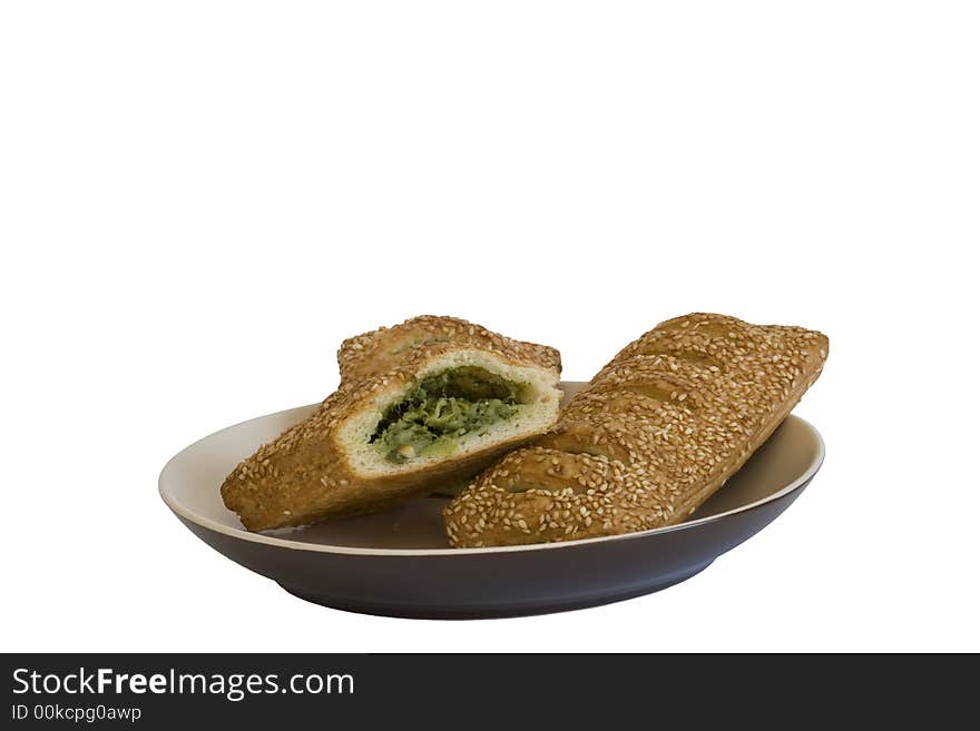 White bread with spinach and sesame on a plate. White bread with spinach and sesame on a plate.