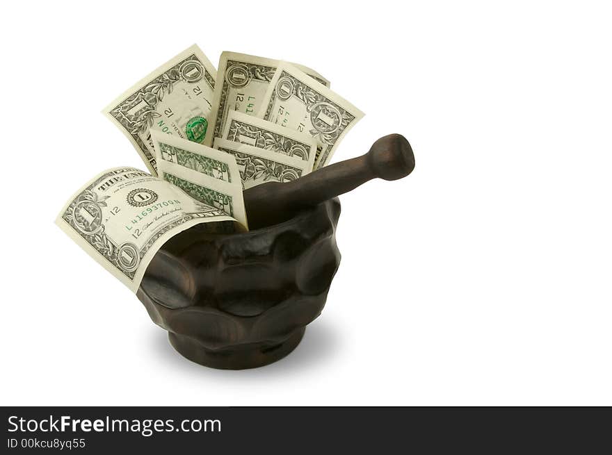 Grinding for Dollars - Wood mortar and pestle containing dollar bills on a white background.