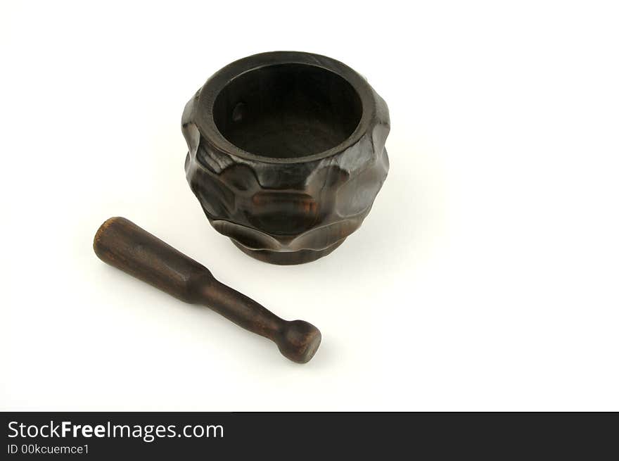 Wood mortar and pestle on a white background.