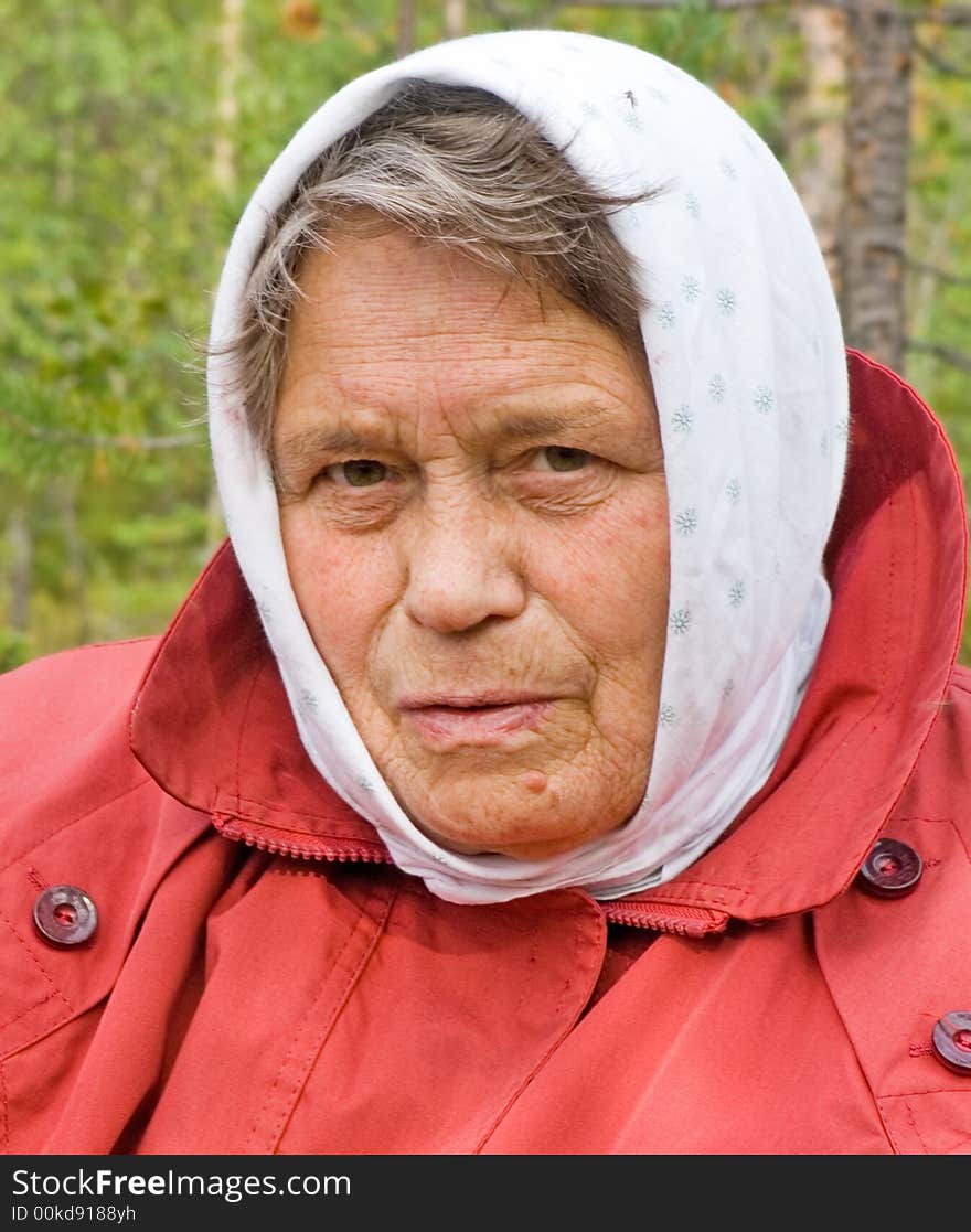 The elderly woman in a scarf. The elderly woman in a scarf