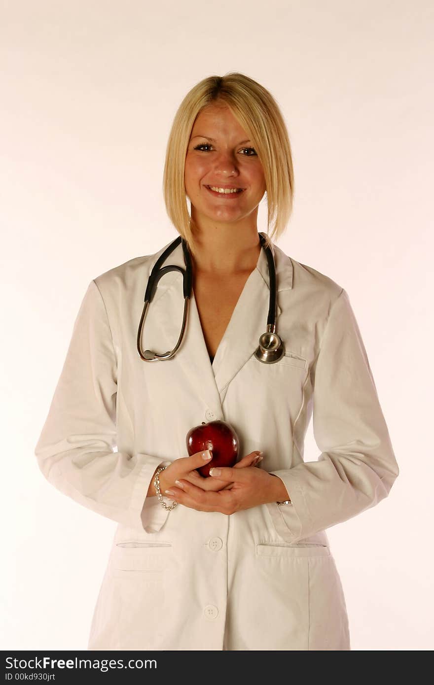 Female doctor holding an apple