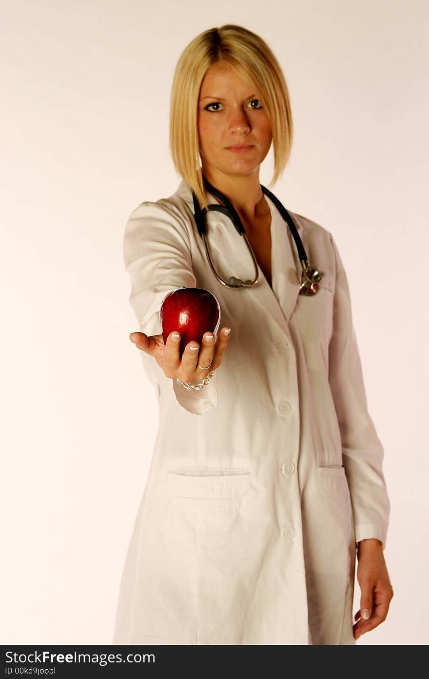 Female doctor holding an apple