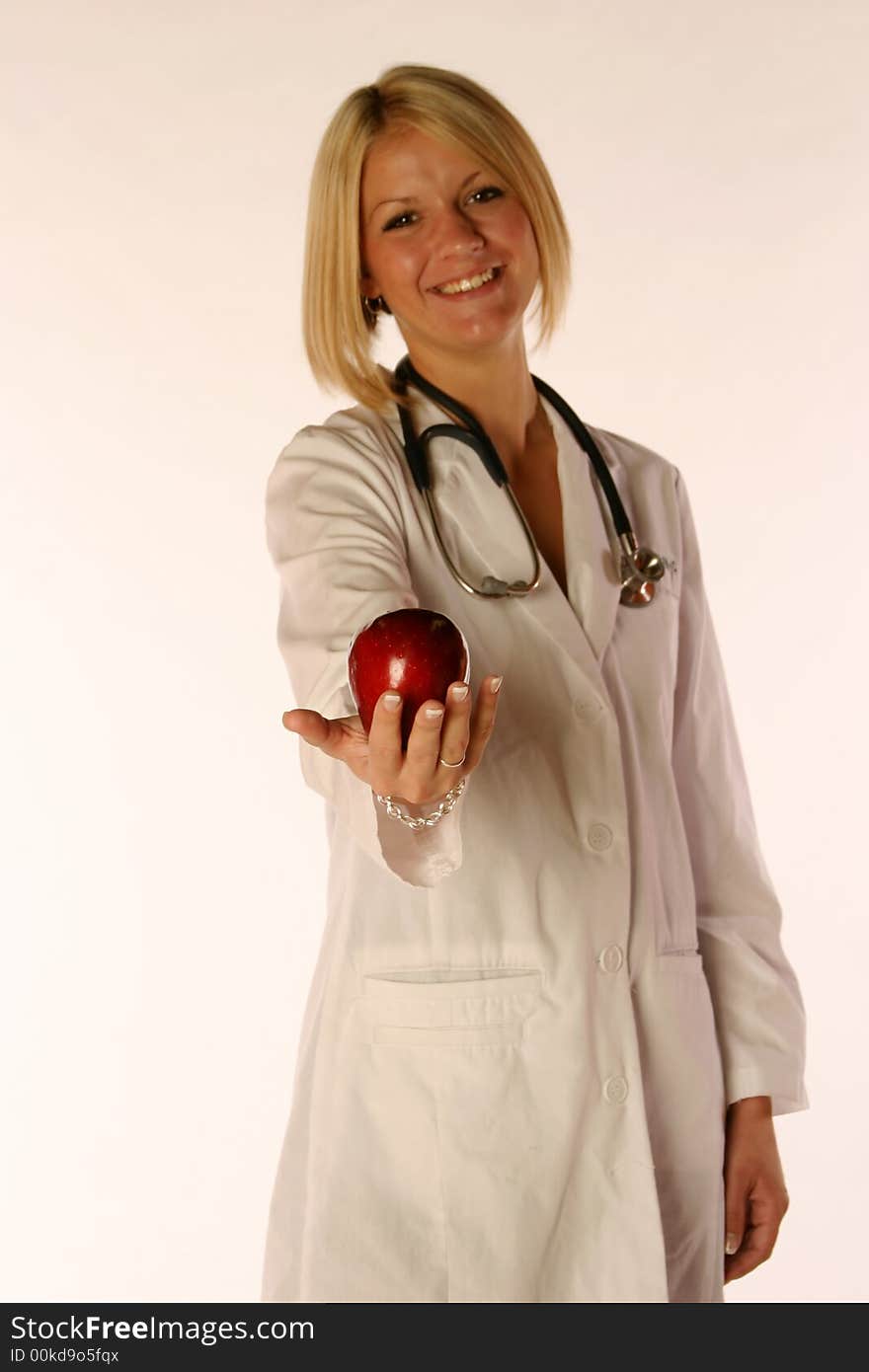 Female doctor holding an apple