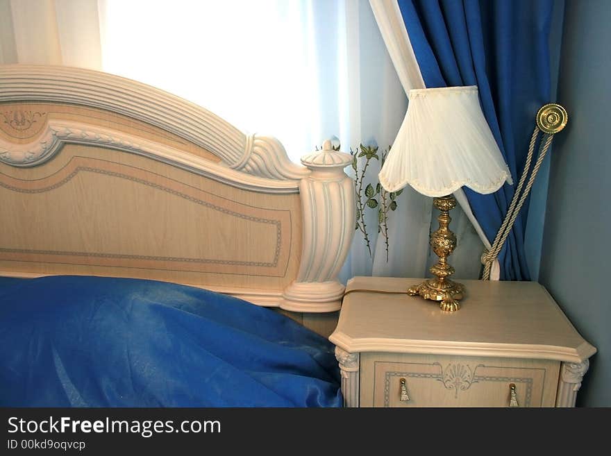 Nice blue bedroom with many luxurious details.