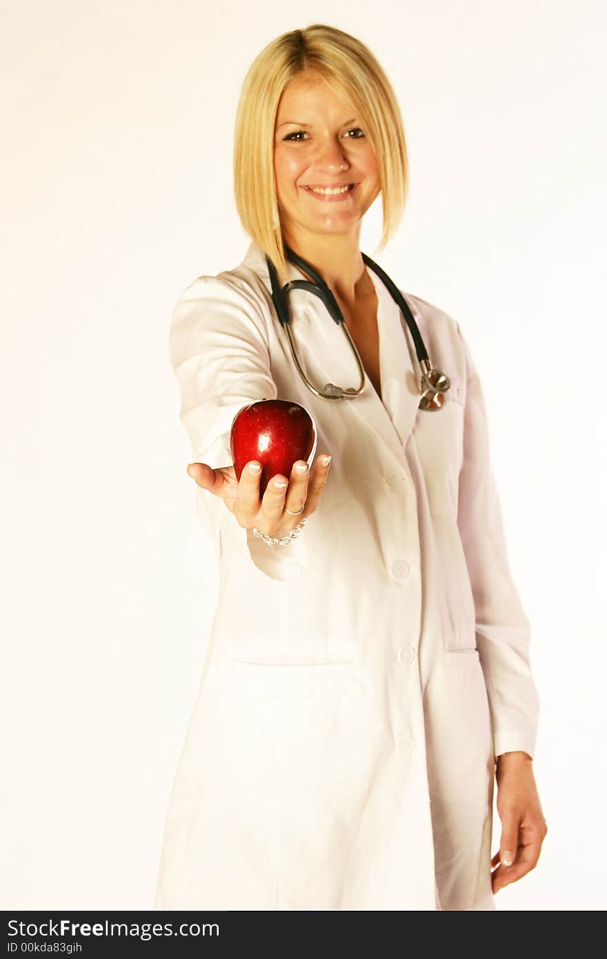 Female doctor holding an apple