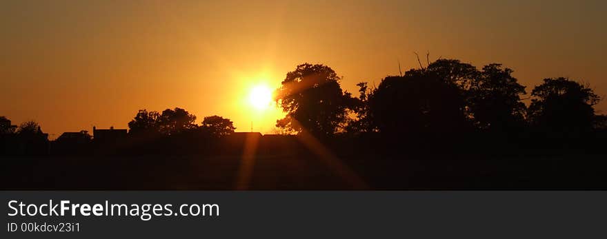 Sunset over fields and trees in UK. Sunset over fields and trees in UK