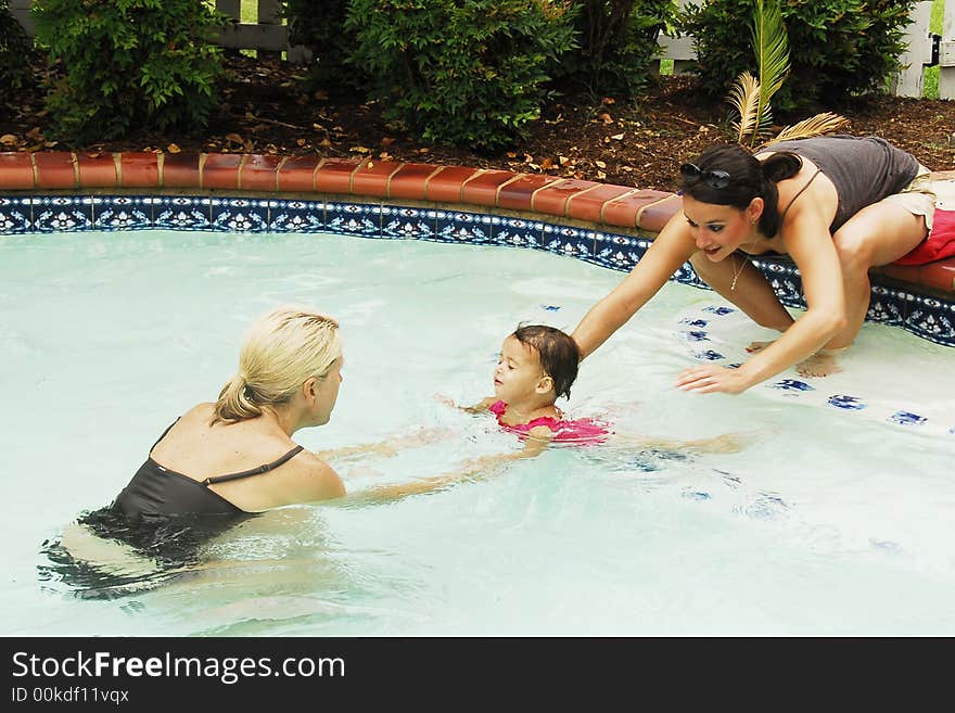 A baby girl at swimming lessons.