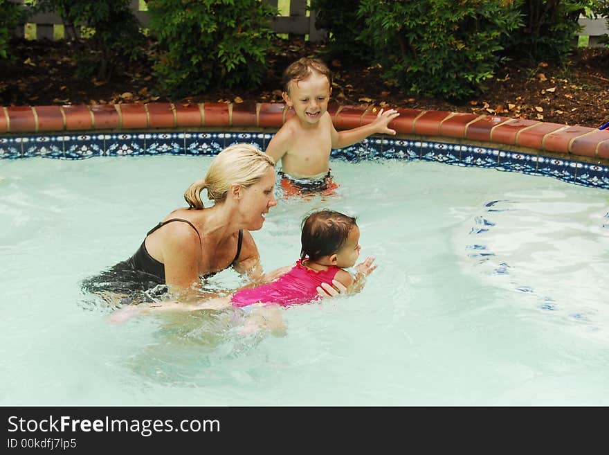 A baby girl at swimming lessons.