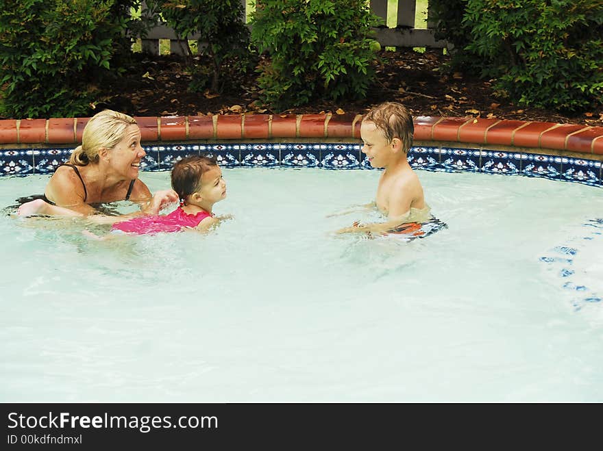 A baby girl at swimming lessons.