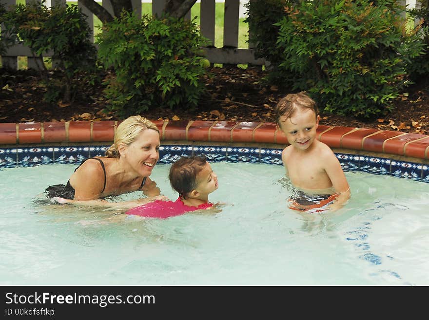 A baby girl at swimming lessons.