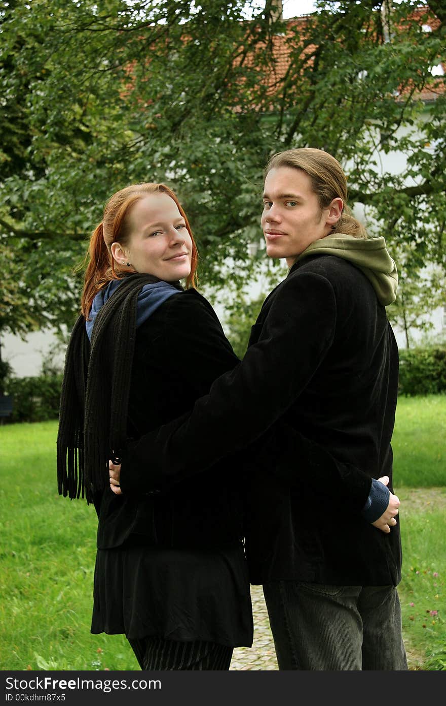 A happy young couple in love taking a stroll around a park. A happy young couple in love taking a stroll around a park.