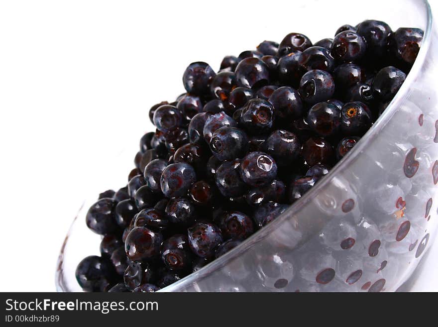 Blueberry close up isolated on white in glass. Blueberry close up isolated on white in glass