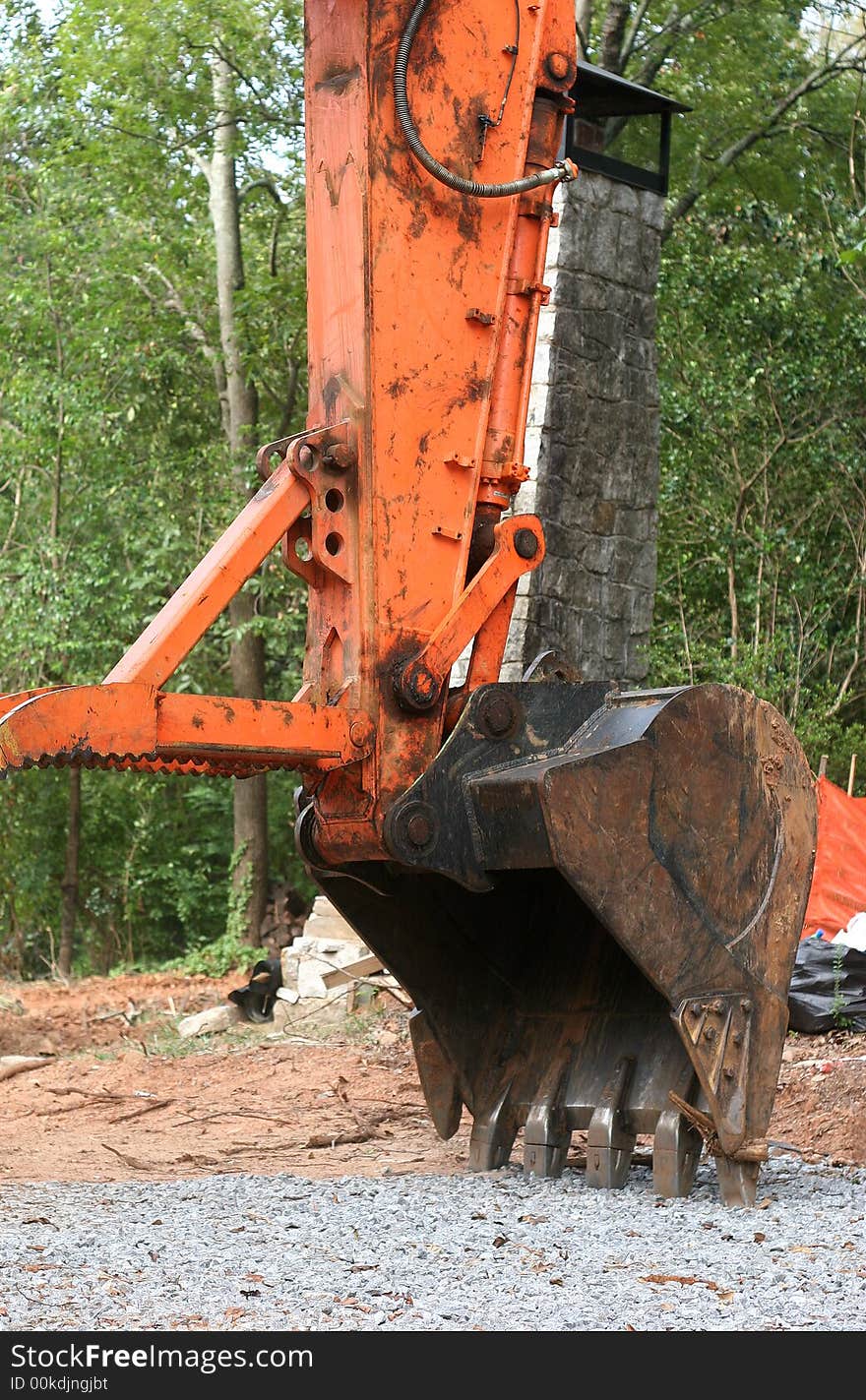 Digging bucket on an orange front end loader. Digging bucket on an orange front end loader