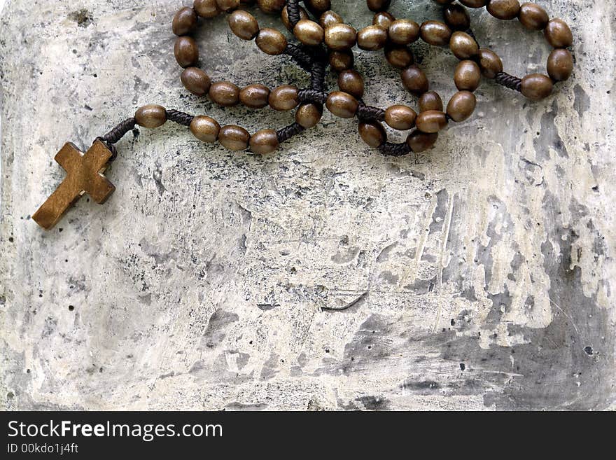 A rosary on a stone background