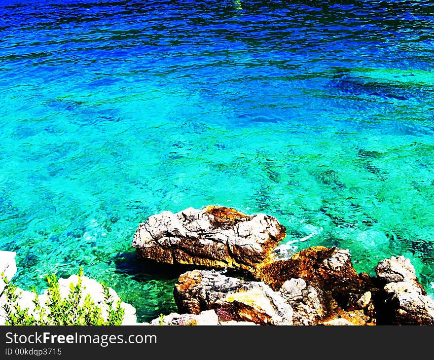 Azure sea water & stony coast. Azure sea water & stony coast