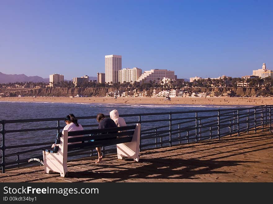 Relaxing on a bench with a city skyline in the background. Relaxing on a bench with a city skyline in the background.