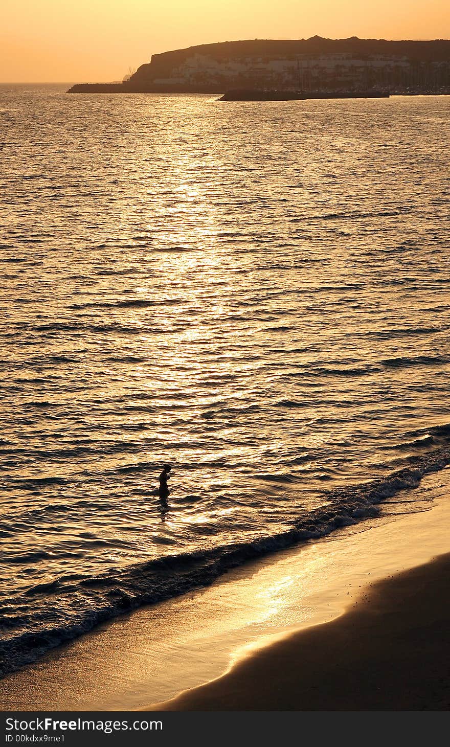 Young woman relaxing in the sea at golden sunset. Young woman relaxing in the sea at golden sunset