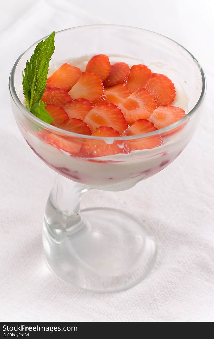 Ice-cream with strawberry in glass vase