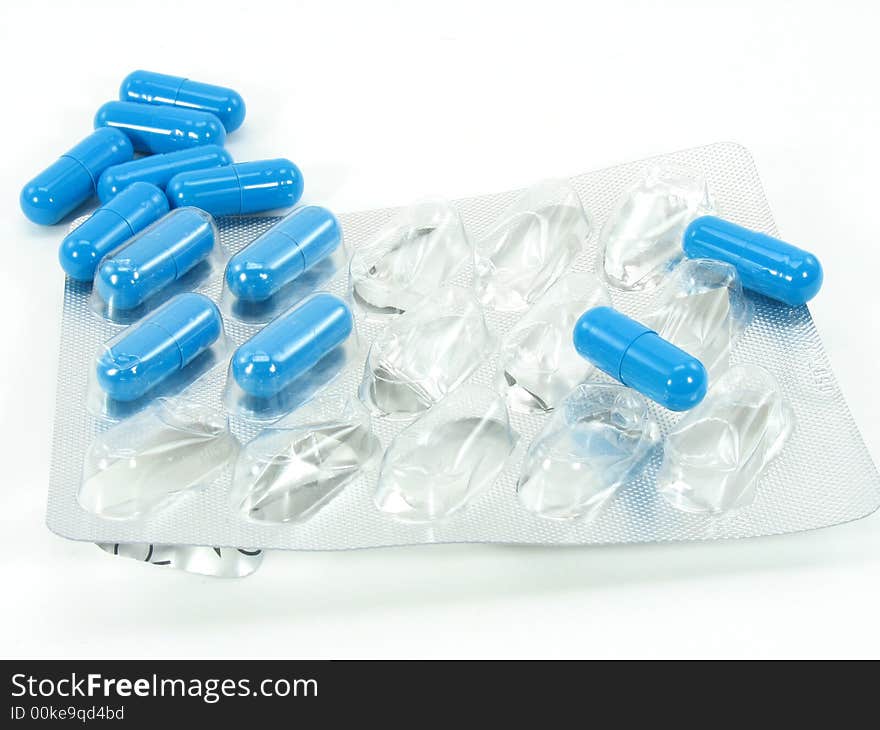 This is a grouping of blue pills on a foil card. Some outside and some still sealed to the container. This is a grouping of blue pills on a foil card. Some outside and some still sealed to the container.