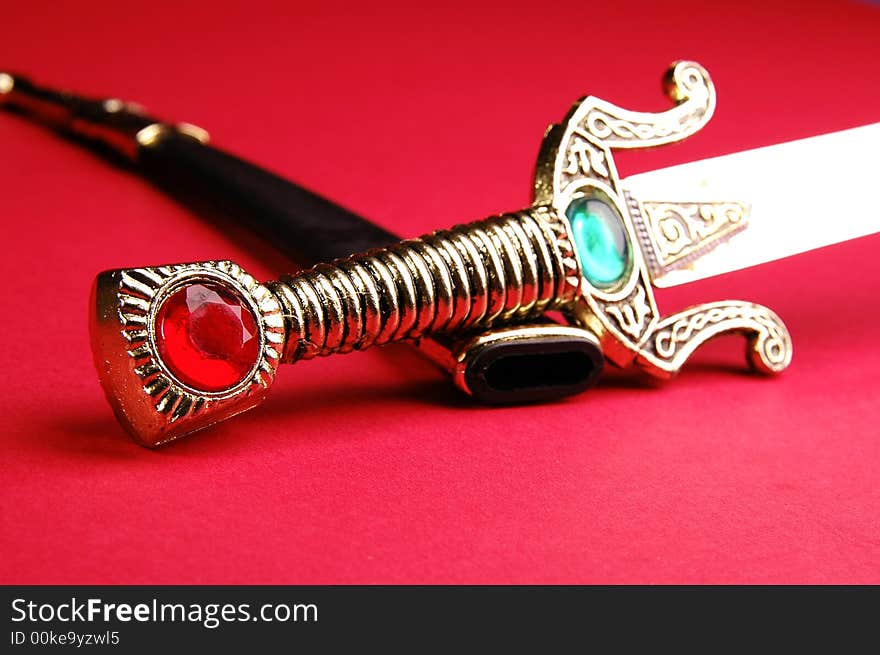 Photo of ornamental knife on the red background