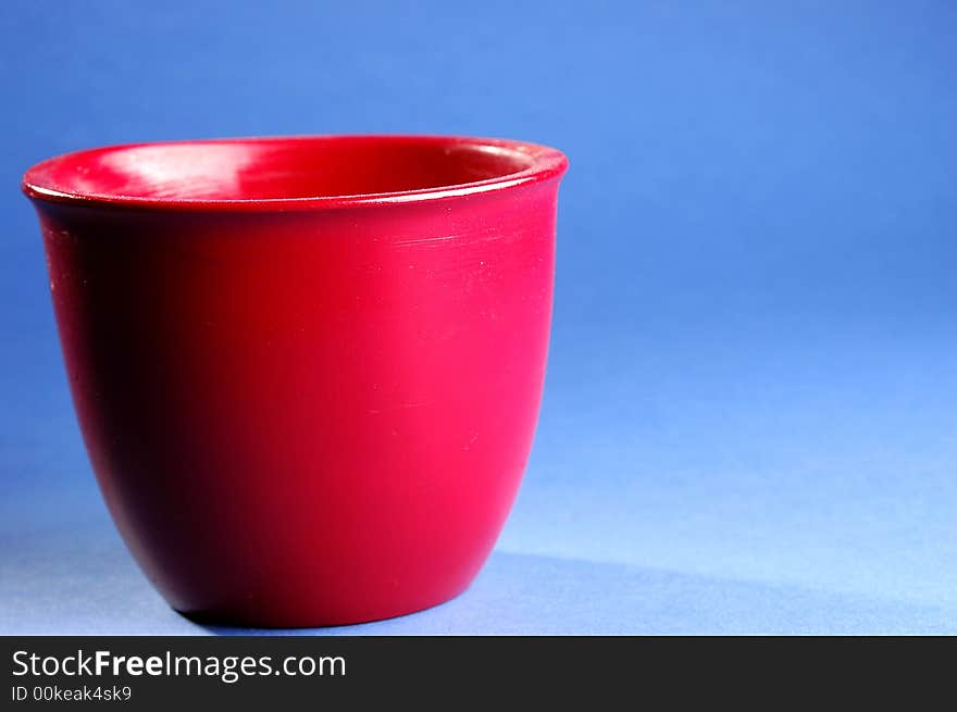 Photo of red vessel isolated on the blue background