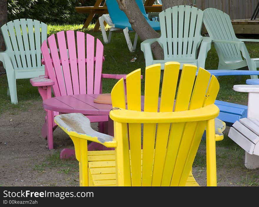 Multi coloured wooden deck chairs in outdoor cafe