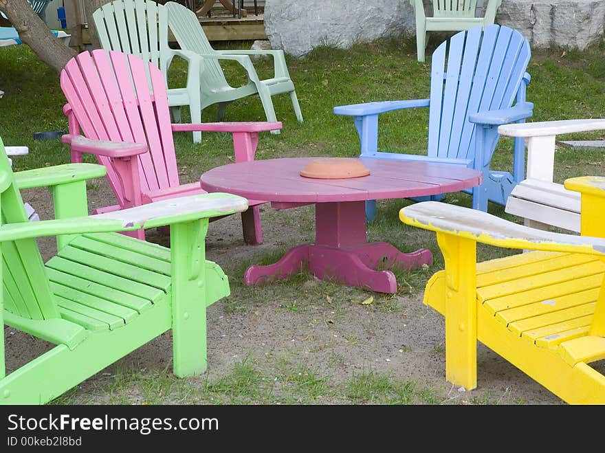 Multi colored wooden deck chairs in outdoor cafe