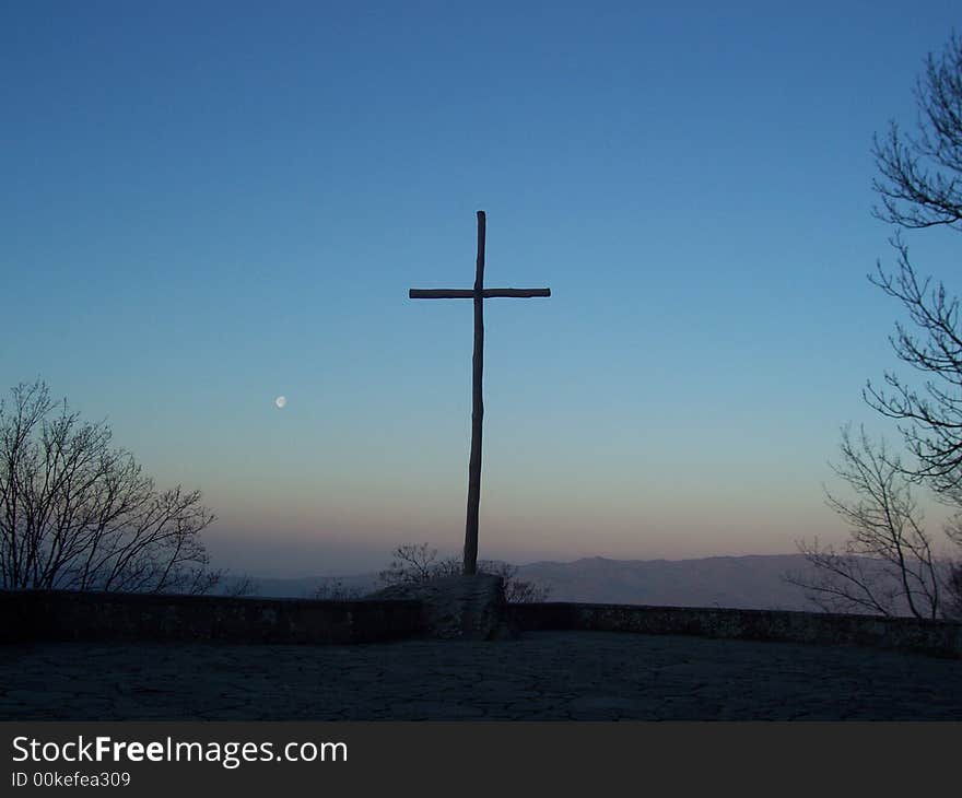 Cross in the sunset with the moon. Cross in the sunset with the moon