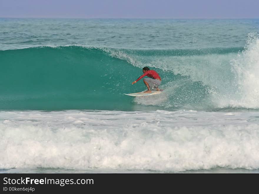 A surfer gets barreled in a perfect glassy wave in Thailand. A surfer gets barreled in a perfect glassy wave in Thailand