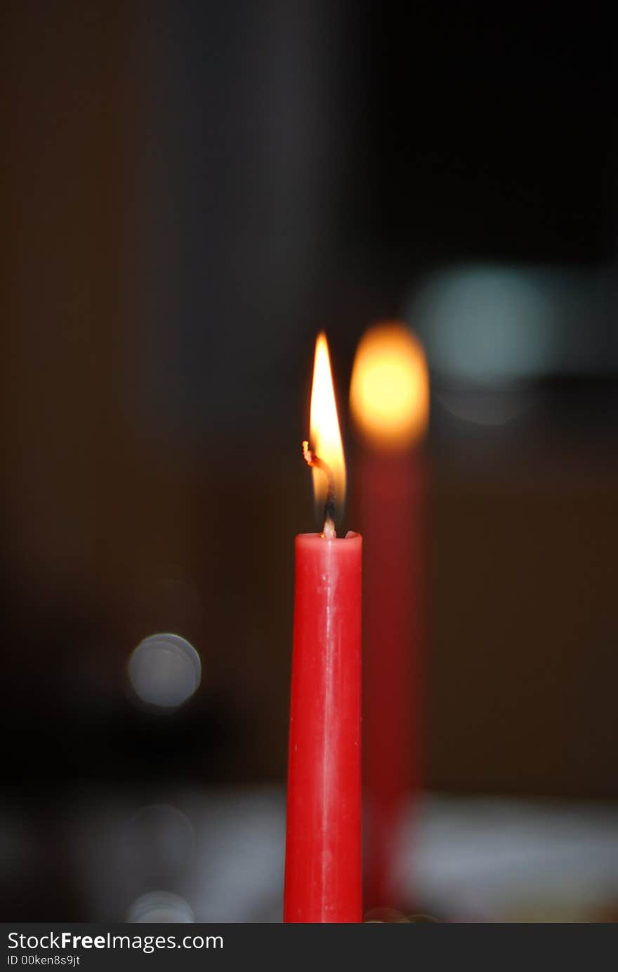 Two red сhristmas candle on a black background